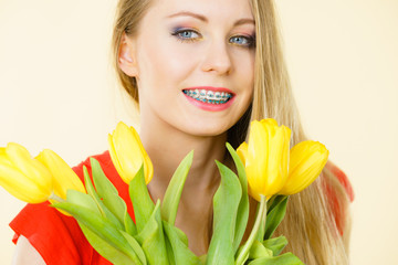 Happy young woman holding tulip bouquet