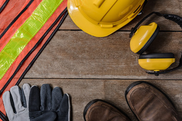 Standard construction safety equipment on wooden table. top view