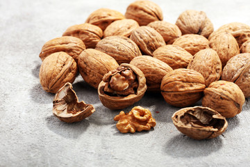 Walnut kernels and whole walnuts on rustic old table