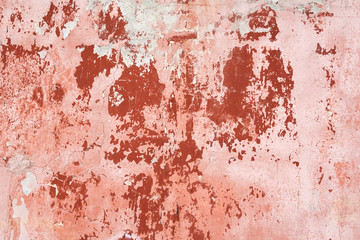 weathered old red and pink painted concrete wall