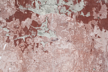 weathered old red and pink painted concrete wall
