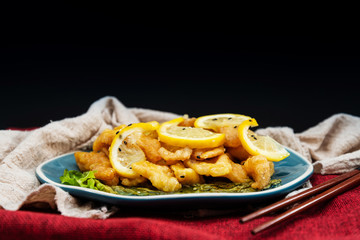 Chinese food fried fish and lemon slices