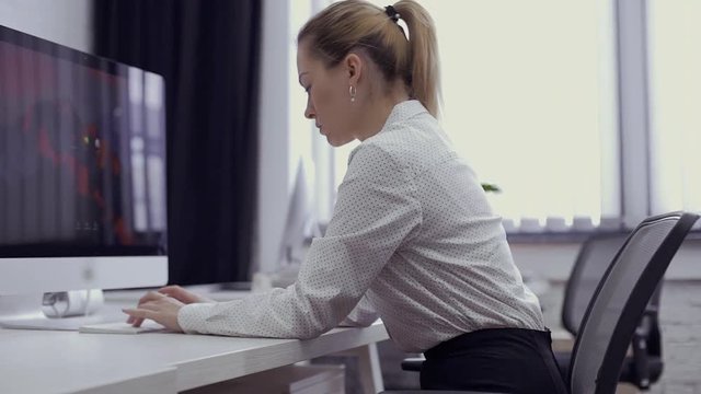 Businesswoman has a pain in shoulder during working on computer in the office