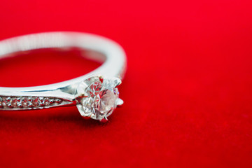 close up luxury wedding diamond ring on red background