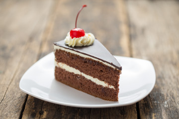 chocolate cake slice on plate on wooden table