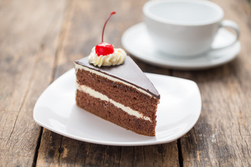chocolate cake slice on plate on wooden table
