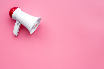 Attract attention concept. Megaphone on pink background top view copy space