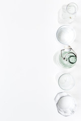Drinks on the table. Pure water in jar and glasses on white background top view space for text