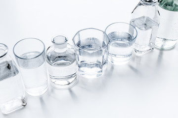 Drinks on the table. Pure water in jar and glasses on white background space for text