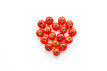 Fresh red tomatoes heart shaped on white background top view copy space