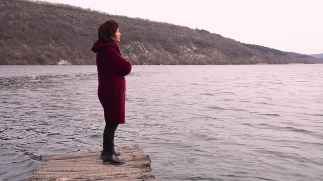 Romantic woman on a old bridge and looking at her
