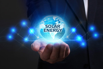 Business, Technology, Internet and network concept. Young businessman working on a virtual screen of the future and sees the inscription: Solar energy