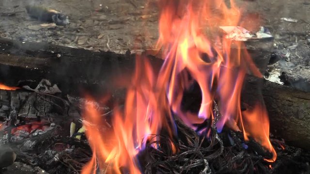 The fire smoke of homeless, burning plastic electronic cables trash, air pollution and fire black, harmful substances phthalates, carbon monoxide carcinogenic