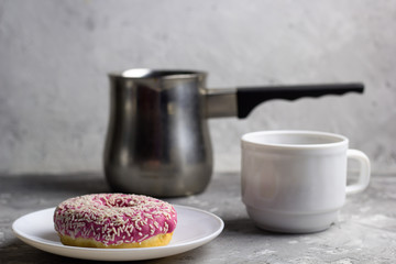close up donut on a plate blurred coffee cups background