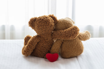 Two Teddy Bears sitting on the bed. Love and relationship concept. 