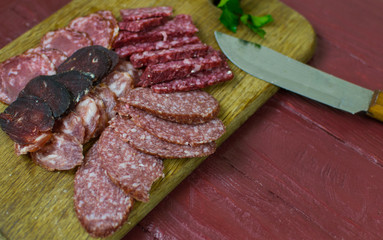 Smoked sausages are cut on a cutting board.