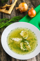 Fresh fish soup with ingredients and spices. Wooden background top view