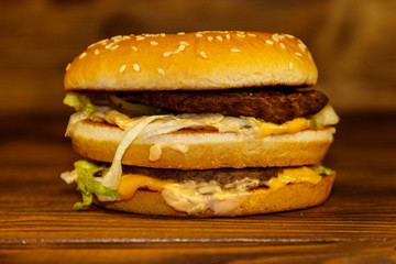 Delicious big hamburger on wooden table