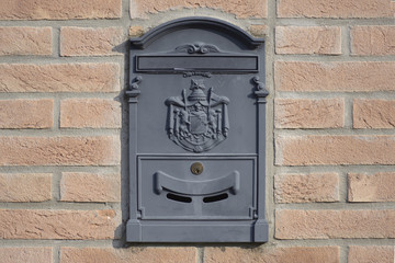 mail box with envelope, on a  wall of briks
