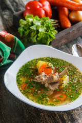 Shurpa from mutton in a white ceramic plate, top view