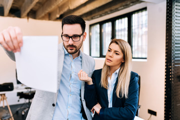 Young business people looking over some documents in the office.