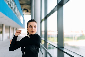 Fototapeta premium Close up image of fit girl stretching indoors.