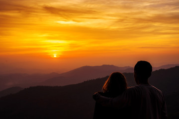 silhouette Couple lover with mountains landscape in beautiful sunset sky