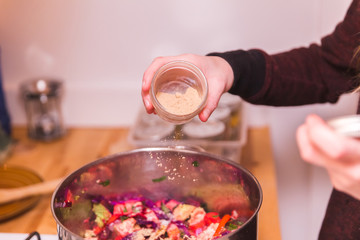 Woman Seasoning Vegetables in Pot
