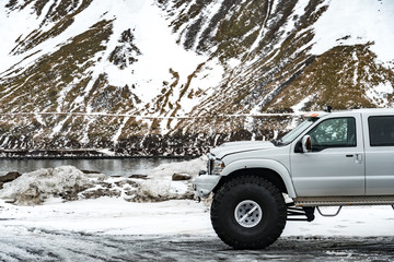 offroad car between snowy mountains