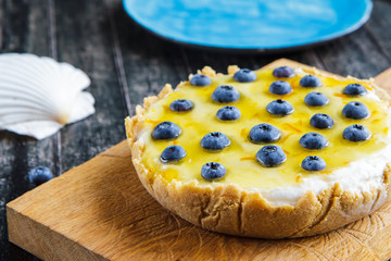 Blueberry cheesecake without baking on a blue plate close-up