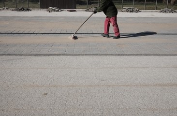 mason at work with the broom