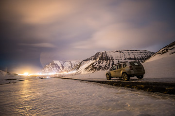 offroad car between snowy mountains