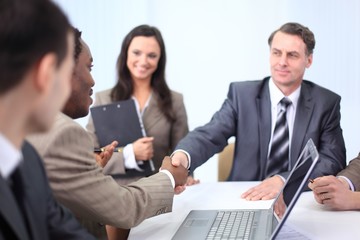 handshake business partners at a business meeting