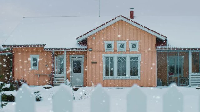 Beautiful Winter View of the Idyllic House with Gorgeous Backyard and a Fence. Soft Snow Falls on a Winter Day. Shot on RED EPIC-W 8K Helium Cinema Camera.