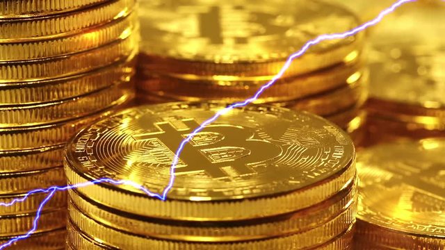 Blockchain technology, Bitcoins mining concept with lightning, macro shot of bitcoins. Cryptocurrency Bitcoin, BTC, power consumption concept