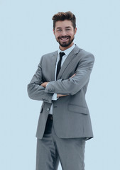 Confident successful businessman in gray suit on white backgroun