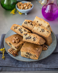 On a plate of mannik with walnuts. Blondie. In pieces. Decorated with mimosa flowers