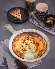 On a ceramic dish, cottage cheese casserole with candied fruits. Russian cheesecake