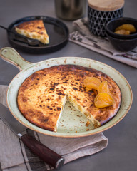 On a ceramic dish, cottage cheese casserole with candied fruits. Russian cheesecake