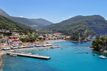 Fototapeta na wymiar Panoramic view of Parga town in Greece on a sunny day with blue sky. Port, jetty, Krioneri beach, island of Panagia