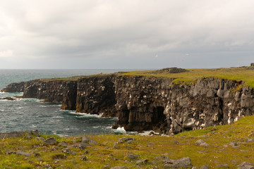 Naklejka premium Southern Peninsula-Travel to Iceland. Spectacular Icelandic landscape with road and scenic nature- fjords, fields, clouds. Driving the Ring Road in Southeast Iceland