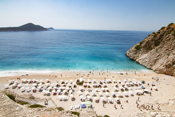 Tourists sunbathing and swimming on the Kaputas Beach, Kas, Antalya Turkey - obrazy, fototapety, plakaty