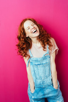 Young laughing woman wearing overalls
