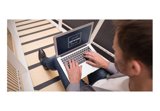 Man Using Laptop on Striped Stairs Mockup