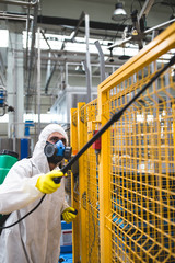 Pest Control Worker Hand Holding Sprayer For Spraying Pesticides in production or manufacturing factory