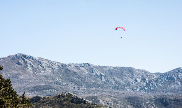 red paraplane in blue sky