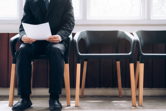 Business people waiting to be called into interview.