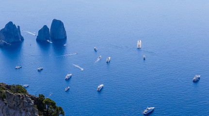Italy. Island Capri. Faraglioni rocks and boats from Monte Solaro, in Anacapri