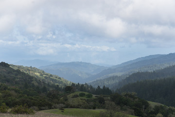 Afternoon sunlight hits the hazy hills of Monte Bello near Palo Alto after a morning rain storm