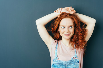 Woman with red hair with her hands to her nape